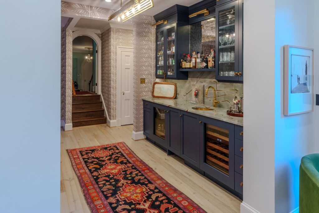 Stylish modern kitchen with dark cabinetry and elegant Persian rug.